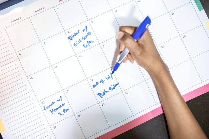 content strategist marking a calendar with optimal publishing dates for new content aligned with AI model updates